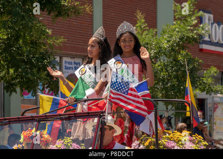 Hispanic beauty queens in the 9th Annual Flower Parade (Desfile de las Flores) in the Jackson Heights neighborhood of Queens in New York on Sunday, July 8, 2018. The parade, complete with silleteros, flower sellers, carrying medallions of flowers on their backs like the silleteros who carry them on their backs down the mountains in Colombia around the city of Medellin to sell at market. Stock Photo