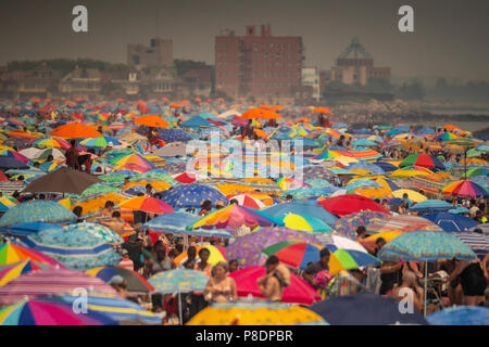 Thousands of beachgoers try to beat the oppressive heat and escape to Coney Island in Brooklyn in New York and literally pack the beach on Sunday, July 1, 2018.  Sunday was the hottest day of 2018, reaching onto the high 90's all over the area, but temperatures are expected to remain in the 90's's all week as a heat wave settles over the city. (© Richard B. Levine) Stock Photo