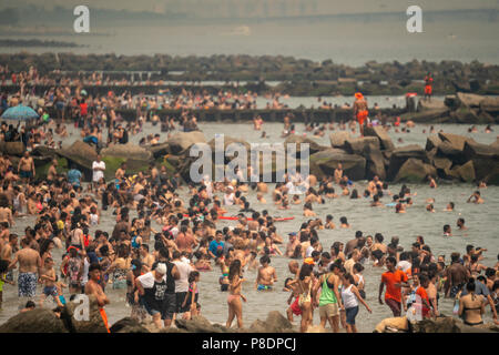 Thousands of beachgoers try to beat the oppressive heat and escape to Coney Island in Brooklyn in New York and literally pack the beach on Sunday, July 1, 2018.  Sunday was the hottest day of 2018, reaching onto the high 90's all over the area, but temperatures are expected to remain in the 90's's all week as a heat wave settles over the city. (Â© Richard B. Levine) Stock Photo