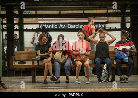 Independence Day subway riders wait for a train at the Atlantic Avenue-Barclays Center station in Downtown Brooklyn in the New York subway on Wednesday, July 4, 2018. (© Richard B. Levine) Stock Photo