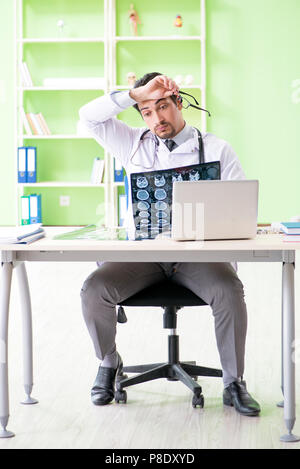 Doctor radiologist looking at x-ray scan in hospital Stock Photo