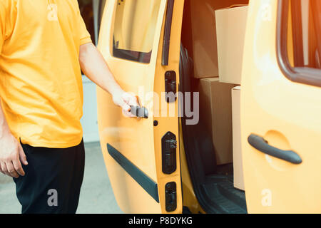 Delivery man closing van. Stock Photo