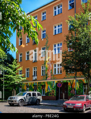 Berlin,Prenzlauerberg,Lychnener strasse. Colourful building with floral painted facade Contains apartments & offices. Street view of block of flats Stock Photo