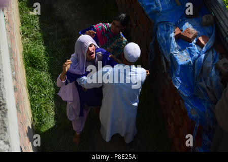 A woman wails as the dead body of a civilian Tamsheel Khan, an 18 year old, who was killed when Indian forces shot him during protests around the gun battle site arrives at his home in Shopian District of Indian Administered Kashmir on 10 July 2018. Two rebels namely Sameer Ahmad Sheikh a local and Babar from Pakistan were killed in an encounter with Indian forces in Shopian district of Kashmir. One of the civilians Tamsheel Khan an 18 year old boy also lost his life when he was shot during the protests around the gun battle site and many suffered injuries. (Photo by Muzamil Mattoo/Pacific Stock Photo