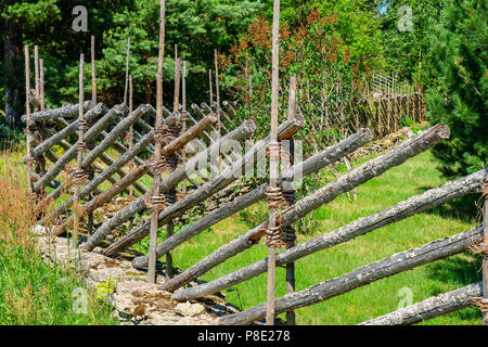 Old wooden roundpole fence in Estonia. Europe Stock Photo