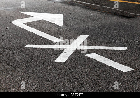 Right turn is prohibited. Crossed white arrow, road marking over black highway asphalt. Close-up photo with selective focus Stock Photo