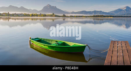 Green rowboat, lake Hopfensee, Hopfen am See, near Füssen, Ostallgäu, Allgäu, Bavaria, Germany Stock Photo