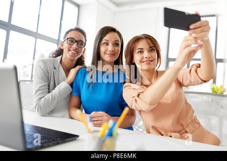 happy businesswomen taking selfie at office Stock Photo