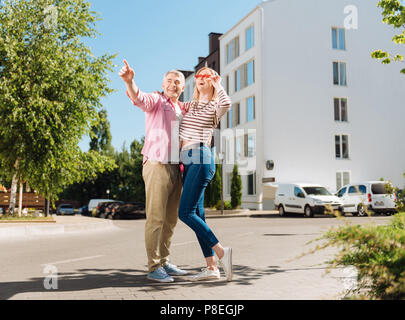 Joyful positive man pointing with his finger Stock Photo