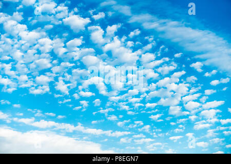 Beautiful vibrant blue sky with lots of small fluffy white clouds forming interesting pattern. Stock Photo