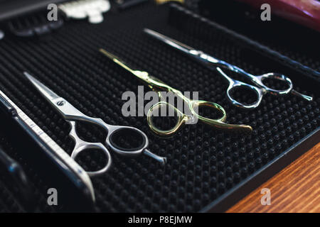 Barbershop Theme. The Tools Of The Hairdresser. Appliances For Haircuts, Hair Styling, Mustaches, Beards. On The Desktop Lie Scissors, Comb, Attachmen Stock Photo