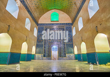 KERMAN, IRAN - OCTOBER 15, 2017: The tiled mihrab with fine floral patterns and Arabic calligraphy in summer prayer hall of Jame Mozaffari Mosque, on  Stock Photo