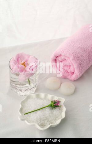 Spa resort therapy composition. Candles, rose flower, salt, towel. Relax, wellness and mindfulness concept Stock Photo