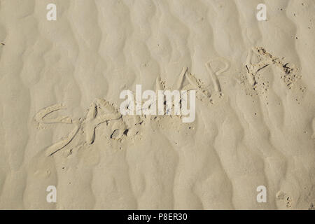 The word SAHARA is written on the sand surface in Sahara Desert Stock Photo