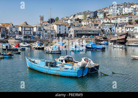 23 May 2018: Brixham, Devon, UK - The harbour with the replica Golden Hind on a fine spring day with clear blue sky. Stock Photo