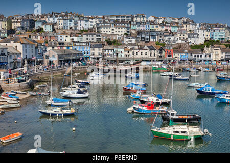 23 May 2018: Brixham, Devon, UK - The harbour with the replica Golden Hind on a fine spring day with clear blue sky. Stock Photo