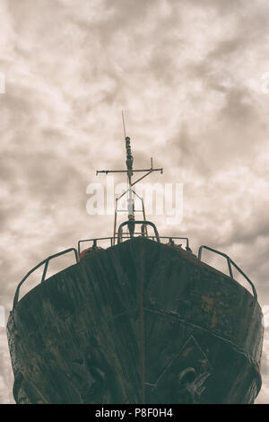 Fisherman's metal trawler with a mast and anchors in the background of dramatic clouds... Stock Photo