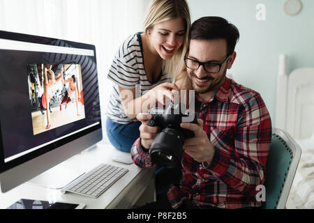 Young couple of designers working on computer Stock Photo