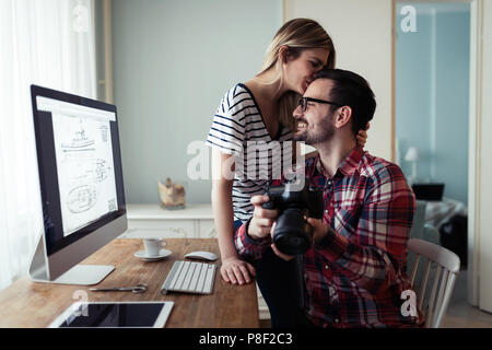 Young couple of designers working on computer Stock Photo