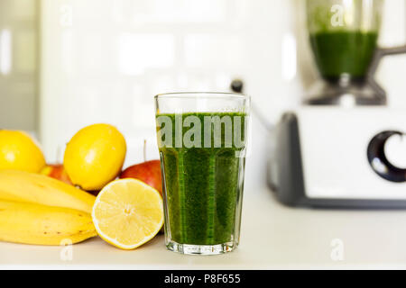 Fresh green smoothie from fruit and vegetables for a healthy lifestyle. Spinach, apple, banana, lemon. Stock Photo