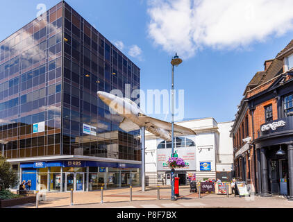 Hawker Hunter aircraft mounted on a pole outside the Big Apple entertainment centre in Crown Square, Woking town centre, Surrey, UK Stock Photo