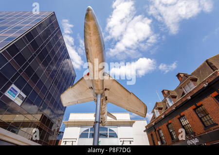 Hawker Hunter aircraft mounted on a pole outside the Big Apple entertainment centre in Crown Square, Woking town centre, Surrey, UK Stock Photo