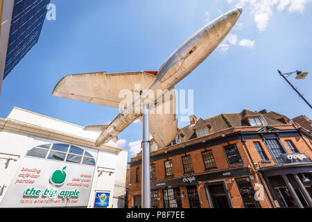 Hawker Hunter aircraft mounted on a pole outside the Big Apple entertainment centre in Crown Square, Woking town centre, Surrey, UK Stock Photo