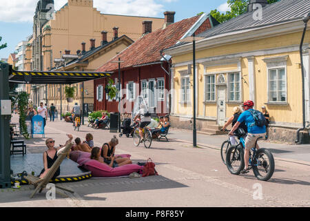 TURKU, FINLAND - 8/7/2018: People enjoying sunny summer day in front of Pharmacy museum and Qwensels house. Stock Photo
