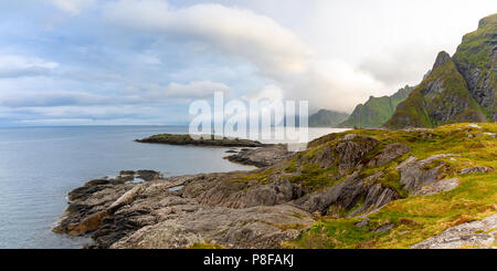 Dramatic sunset clouds moving over steep mountain peaks, Lofoten islands, Norway Stock Photo