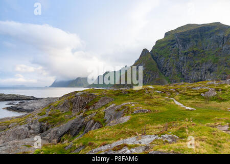 Dramatic sunset clouds moving over steep mountain peaks, Lofoten islands, Norway Stock Photo