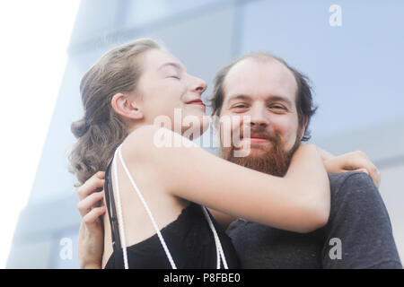 Smiling couple standing outdoors embracing Stock Photo