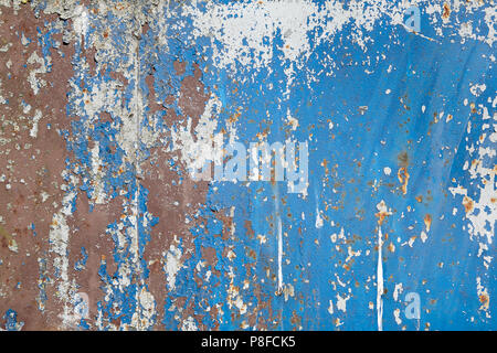 Metal painted blue wall texture with exfoliating paint. Stock Photo