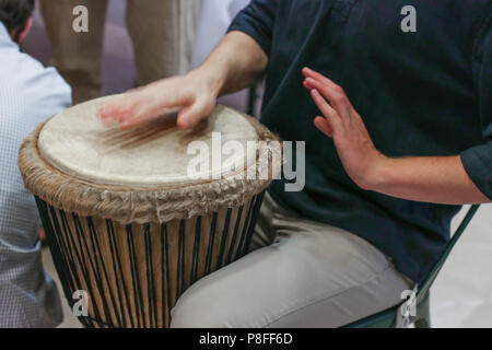 Drummers hands on an african djembe drum musical instrument ethnic beat music concept Stock Photo