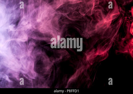 Dense multicolored smoke of   pink, red and purple colors on a black isolated background. Background of smoke vape Stock Photo