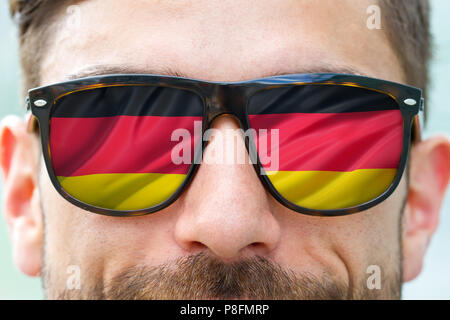 Man with german flag in his glasses Stock Photo