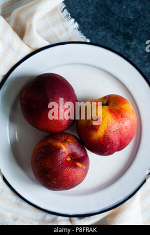 Nectarines on a white plate Stock Photo