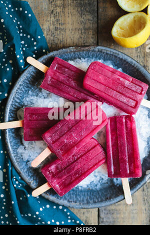 Red popsicles on ice Stock Photo
