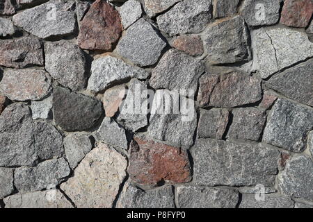 Rubble gray and brown stone wall, rubblework. Stock Photo