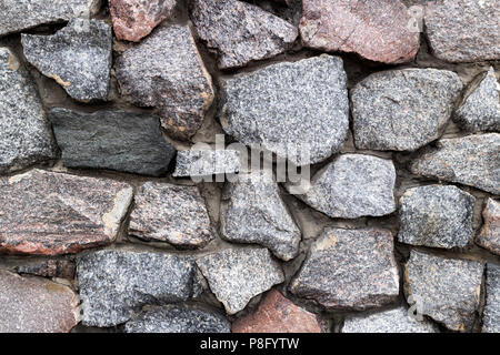 Rubble grey and brown stone wall, rubble work. Stock Photo