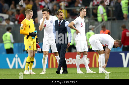 England manager Gareth Southgate (centre) speaks with England players ahead of extra time during the FIFA World Cup, Semi Final match at the Luzhniki Stadium, Moscow. Stock Photo