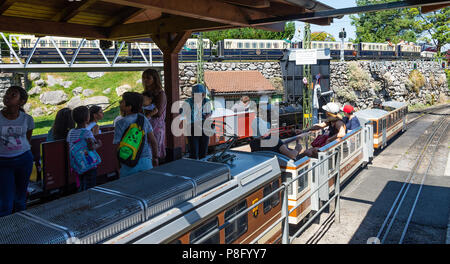 Two Miniature Passenger Trains at Chablais-City Railway Station at the Swiss Vapeur Parc by Lake Geneva Le Bouveret Switzerland Stock Photo