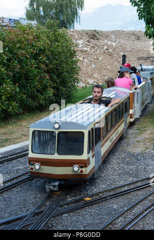 A Small Scaled Model Electric Train Giving Rides to Tourists at the Swiss Vapeur Parc at Le Bouveret Lake Geneva Switzerland Stock Photo