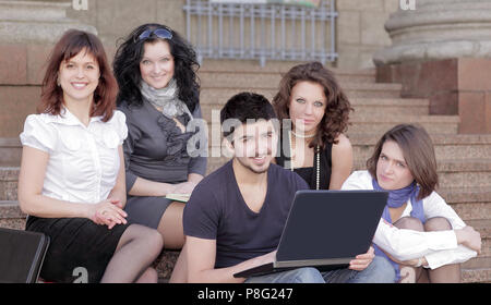 group of students communicating via the Internet using laptop Stock Photo
