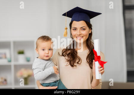 mother student with baby boy and diploma at home Stock Photo