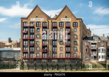 Riverside elevations of St John's Wharf, a former warehouse now a luxury apartment block, and Captain Kidd, now a riverside pub. Wapping, London, UK. Stock Photo