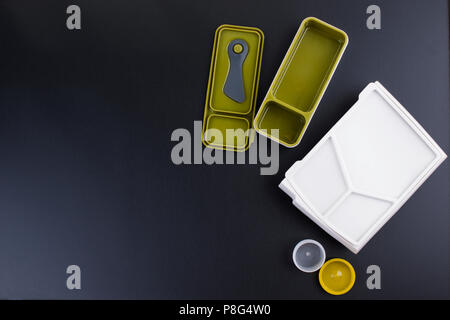 A set of clean plastic lunchboxes. Trend for the office. Black background. New dishes. Copy space Stock Photo