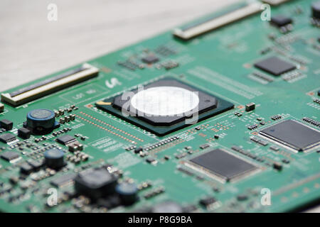 Close up photo of circuit board on wooden background Stock Photo