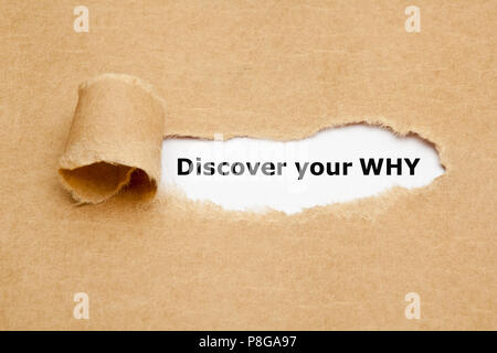 Printed text Discover Your Why appearing behind ripped brown paper. Stock Photo