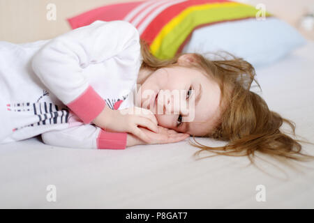 Little preschooler girl in pajamas on sunny morning Stock Photo