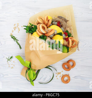 Bouquet consisting of honey, a bunch of bagels, mint leaves, lemons, lime, ginger and red currant on the white Stock Photo